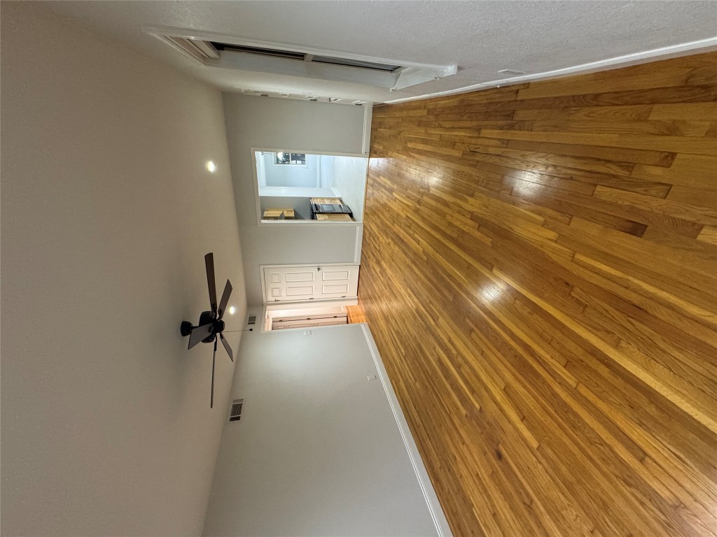 1009 Alegria Road Austin, TX 78757 - Photo 9 of 27 a view of a room with a wooden floor