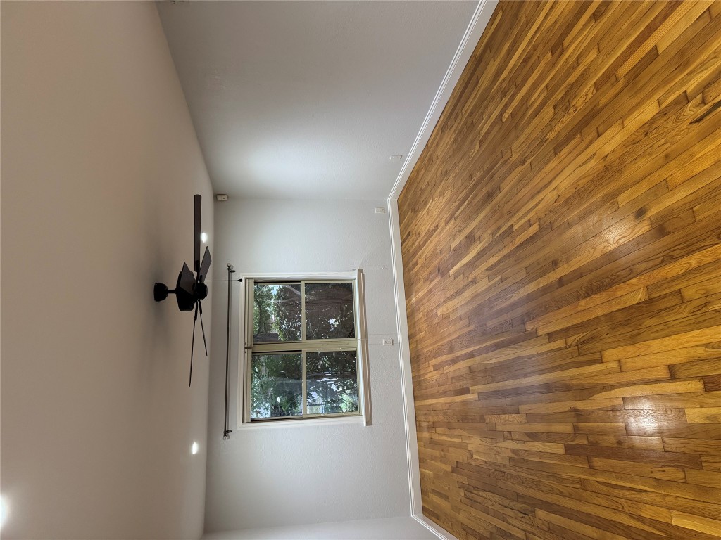 1009 Alegria Road Austin, TX 78757 - Photo 10 of 27 a view of an empty room with wooden floor and a window