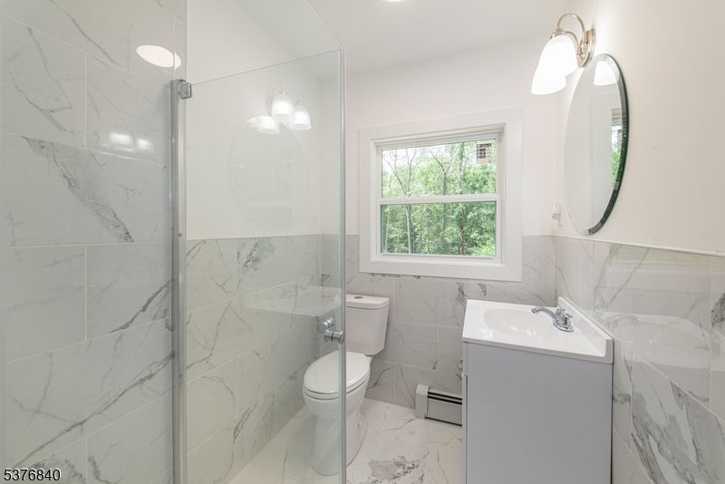 25 East Shore Lake Owassa Road Newton, NJ 07860 - Photo 12 of 19 a bathroom with a sink a toilet and shower