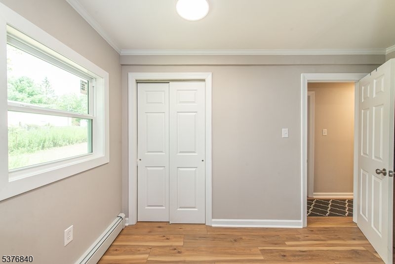 25 East Shore Lake Owassa Road Newton, NJ 07860 - Photo 13 of 19 a view of a livingroom with wooden floor and closet
