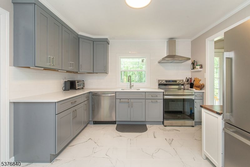 25 East Shore Lake Owassa Road Newton, NJ 07860 - Photo 6 of 19 a kitchen with a sink stove and cabinets