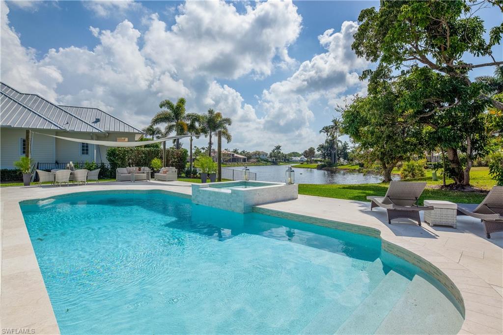 an outdoor space with swimming pool and furniture