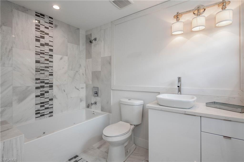 512 Whispering Pine Lane Naples, FL 34103 - Photo 13 of 24 a bathroom with a sink toilet and shower