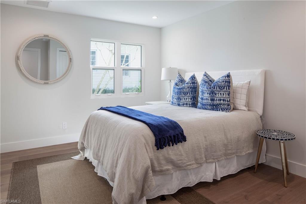 512 Whispering Pine Lane Naples, FL 34103 - Photo 14 of 24 a bed sitting in a bedroom next to a window