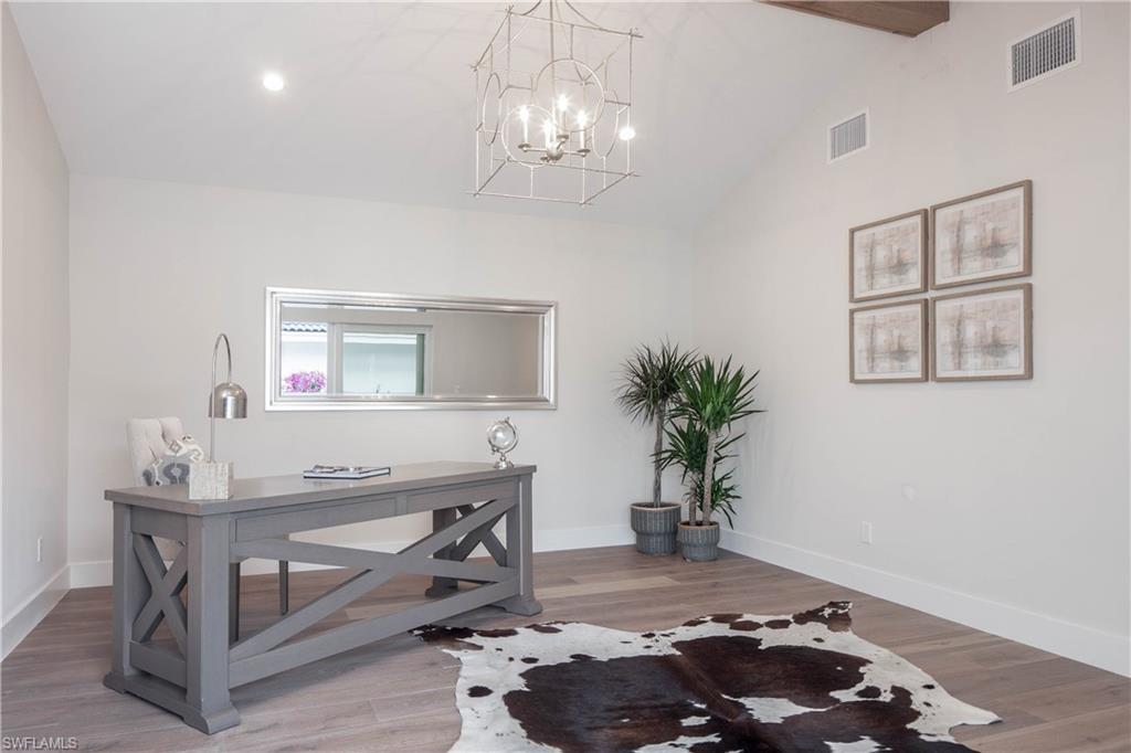 512 Whispering Pine Lane Naples, FL 34103 - Photo 18 of 24 a workspace with furniture and a chandelier