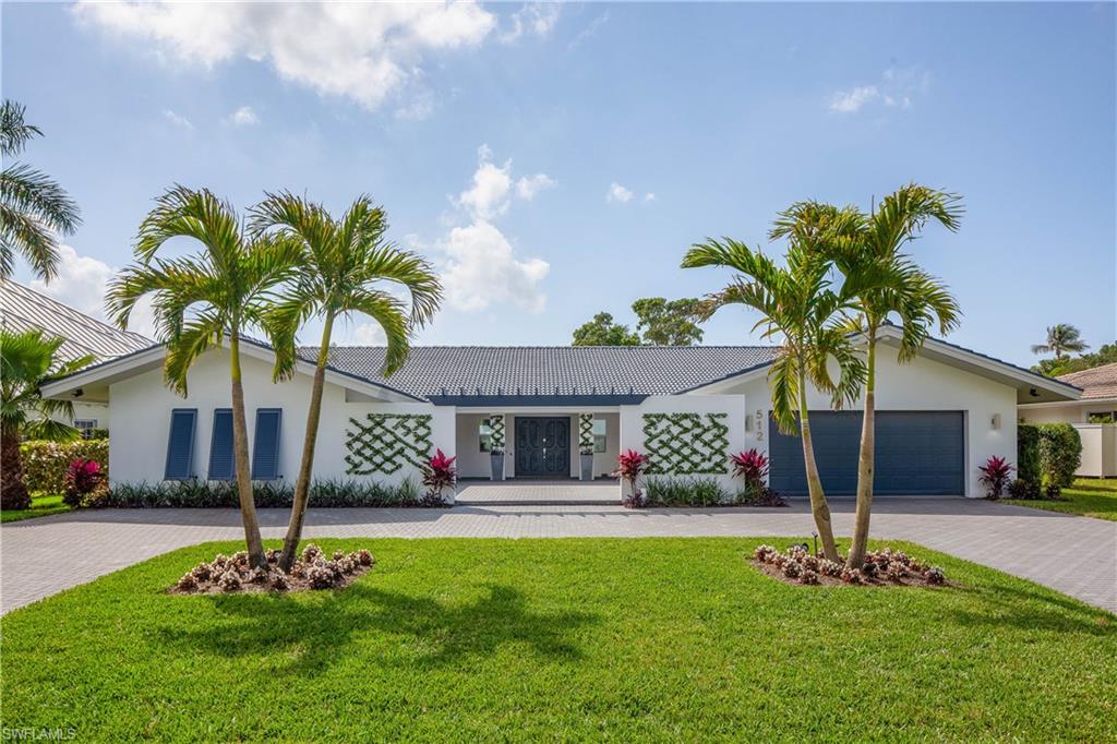 512 Whispering Pine Lane Naples, FL 34103 - Photo 19 of 24 a front view of a house with garden
