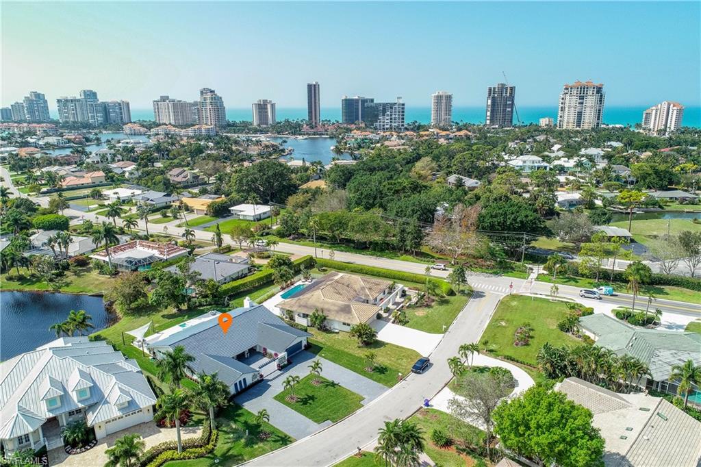 512 Whispering Pine Lane Naples, FL 34103 - Photo 20 of 24 an aerial view of a city with lots of residential buildings