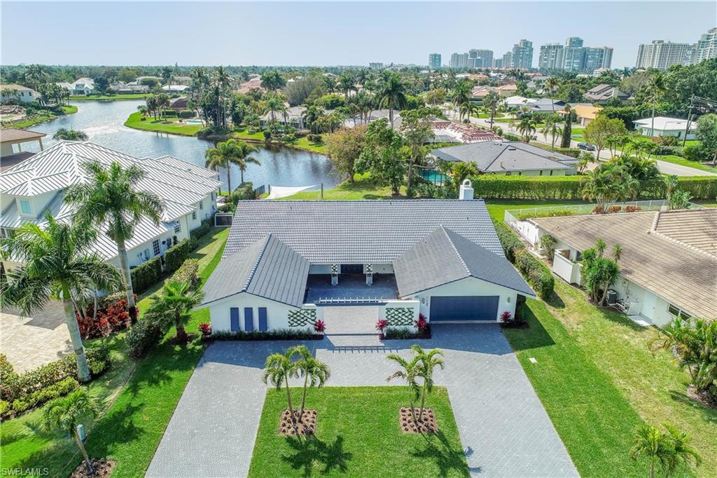 512 Whispering Pine Lane Naples, FL 34103 - Photo 22 of 24 a aerial view of a house with a garden