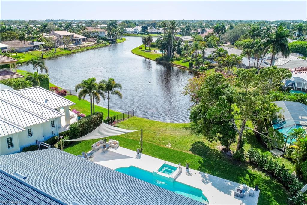 512 Whispering Pine Lane Naples, FL 34103 - Photo 23 of 24 an aerial view of a house with outdoor space swimming pool and lake view