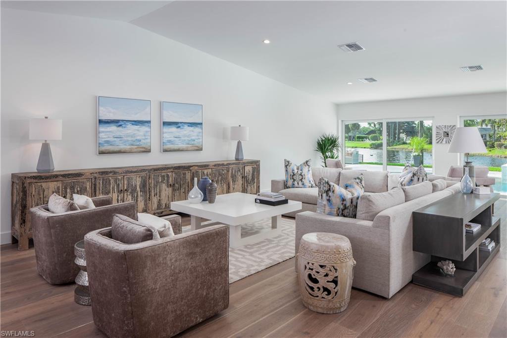 512 Whispering Pine Lane Naples, FL 34103 - Photo 3 of 24 a living room with furniture and a fireplace