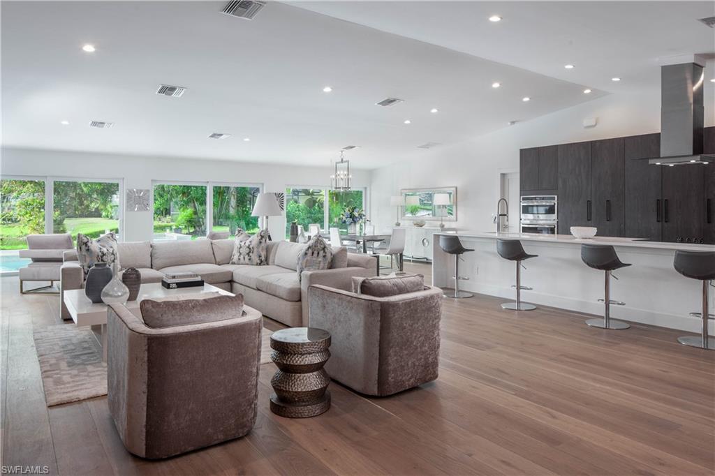512 Whispering Pine Lane Naples, FL 34103 - Photo 4 of 24 a living room with furniture and a large window