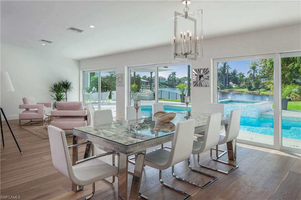512 Whispering Pine Lane Naples, FL 34103 - Photo 6 of 24 a view of a dining room with furniture window and wooden floor