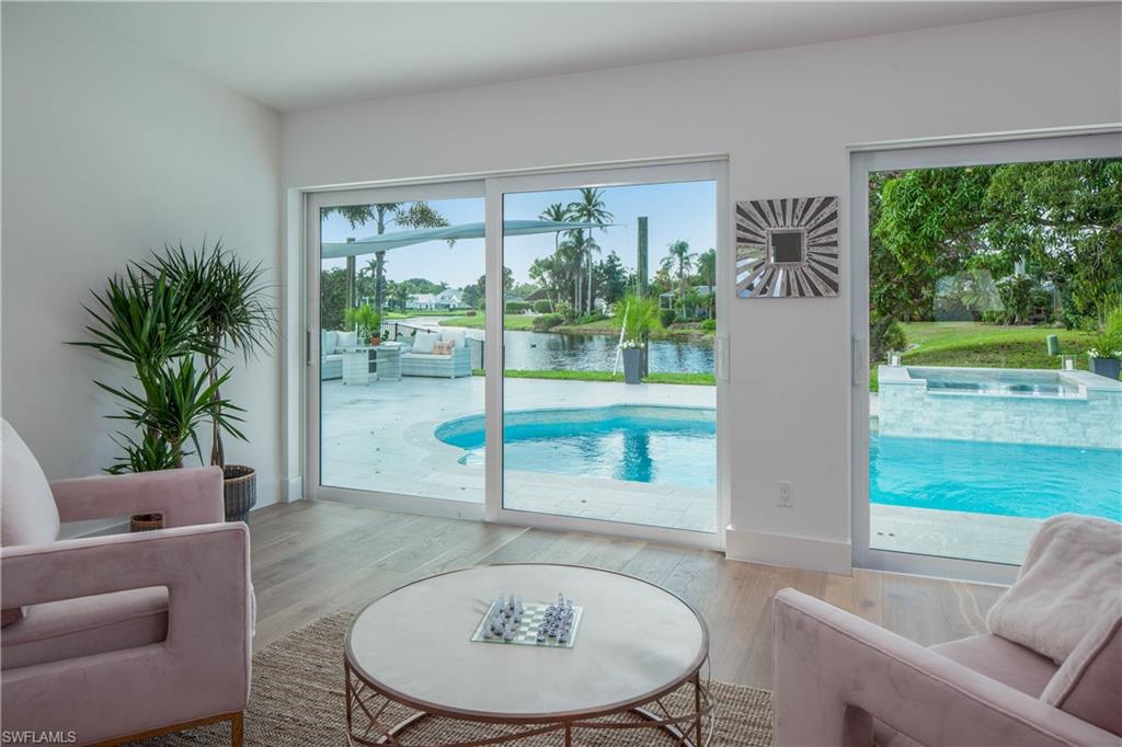 512 Whispering Pine Lane Naples, FL 34103 - Photo 7 of 24 a living room with furniture and a large window