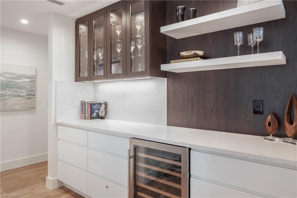 512 Whispering Pine Lane Naples, FL 34103 - Photo 8 of 24 a bathroom with a sink and a mirror