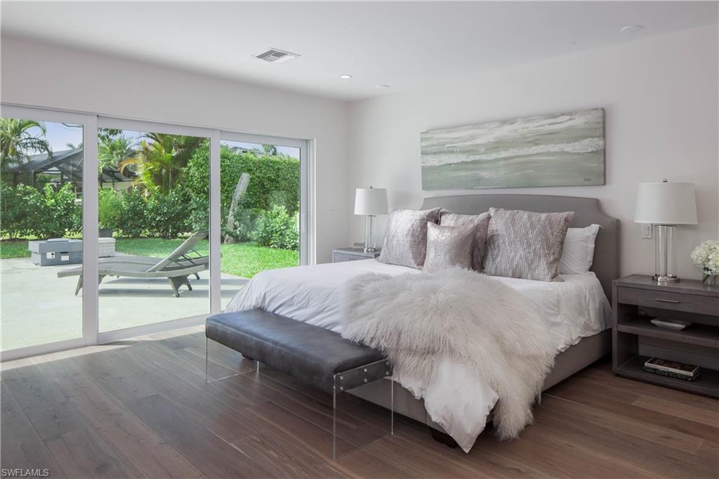 512 Whispering Pine Lane Naples, FL 34103 - Photo 9 of 24 a bed sitting in a bedroom next to a window