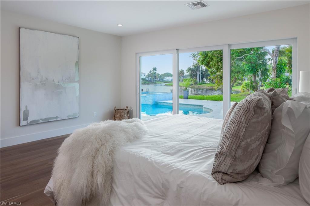 512 Whispering Pine Lane Naples, FL 34103 - Photo 10 of 24 a bed sitting in a bedroom next to a window