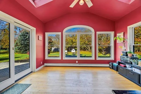 a view of an empty room with large windows and a swimming pool