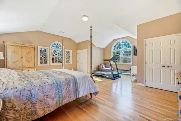 a bed room with a bed window and a chair