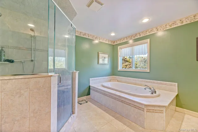 a bathroom with a sink a toilet a shower and a mirror