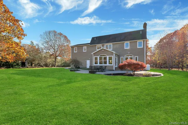 a view of house with backyard