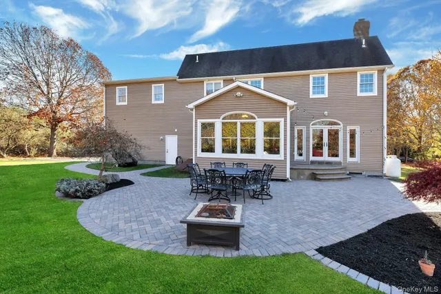 a front view of a house with a garden and patio