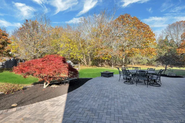 a view of a backyard with sitting area