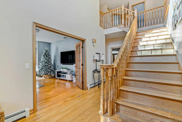 a view of entryway and hall with wooden floor