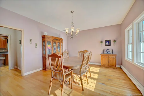 a dining room with furniture and window wooden floor