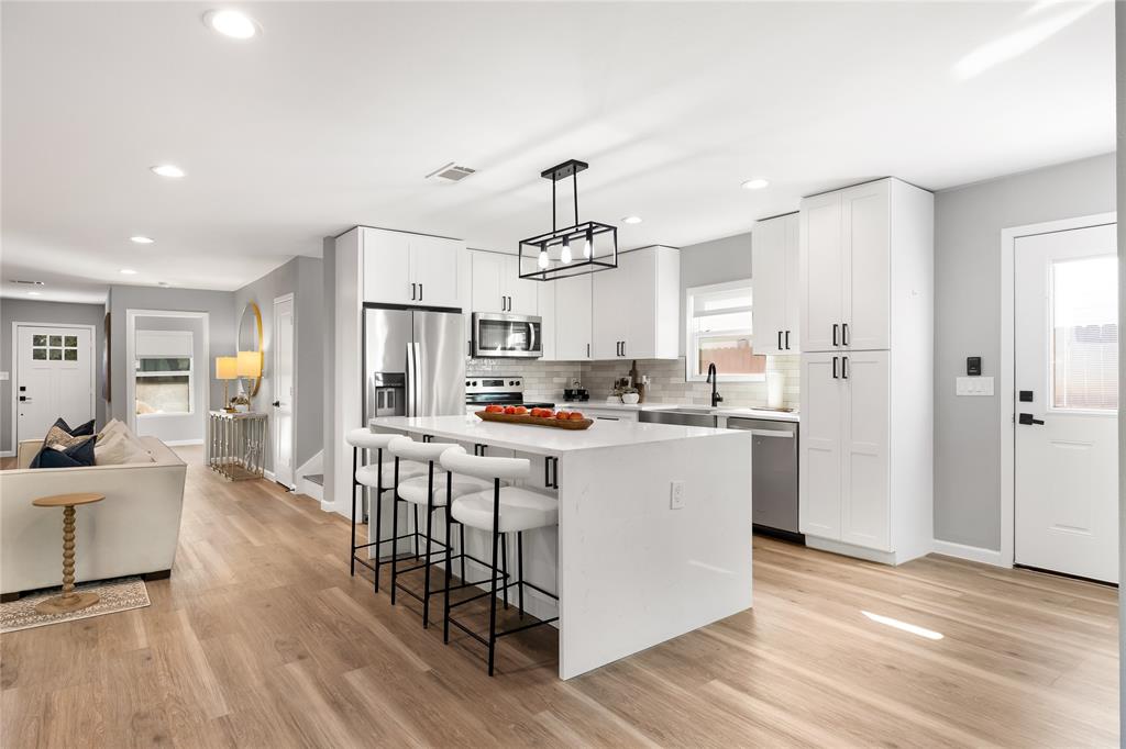 2728 Livingston Avenue Fort Worth, TX 76110 - Photo 37 of 37 a kitchen with white cabinets and refrigerator