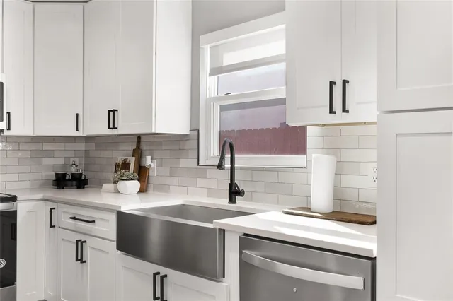 a kitchen with a sink cabinets and appliances