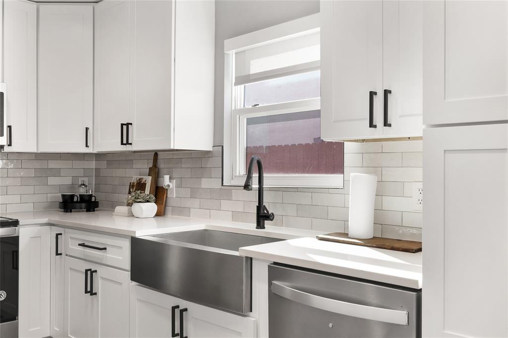 2728 Livingston Avenue Fort Worth, TX 76110 - Photo 13 of 37 a kitchen with a sink cabinets and appliances