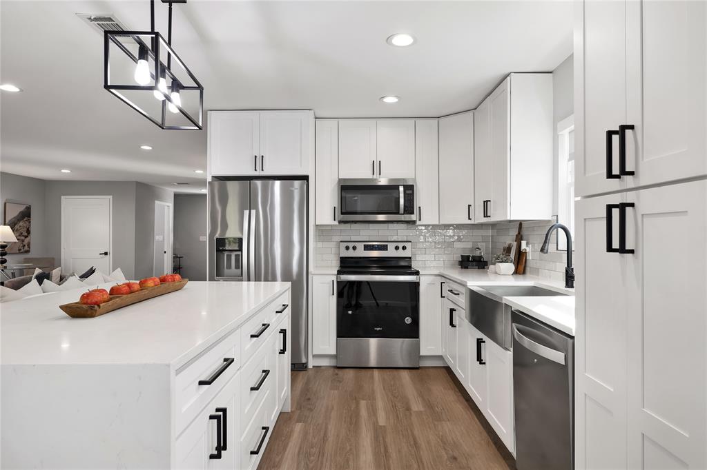 2728 Livingston Avenue Fort Worth, TX 76110 - Photo 14 of 37 a kitchen with stainless steel appliances a stove refrigerator sink and microwave