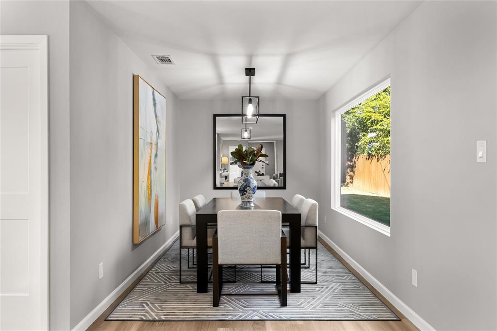 2728 Livingston Avenue Fort Worth, TX 76110 - Photo 15 of 37 a dining room with furniture a chandelier and wooden floor