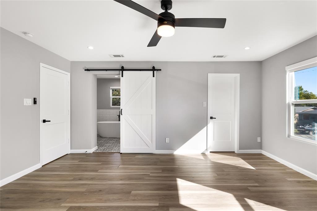 2728 Livingston Avenue Fort Worth, TX 76110 - Photo 20 of 37 a view of a livingroom with wooden floor a ceiling fan and windows