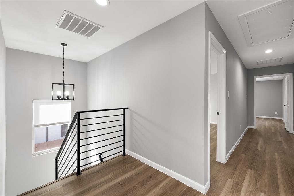 2728 Livingston Avenue Fort Worth, TX 76110 - Photo 30 of 37 a view of a hallway with wooden floor and staircase