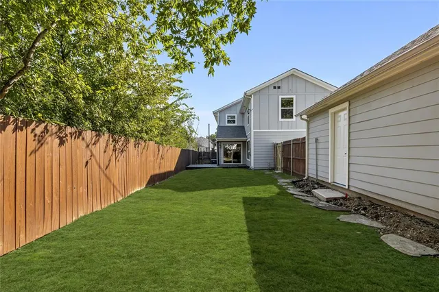 a view of an house with backyard space and garden