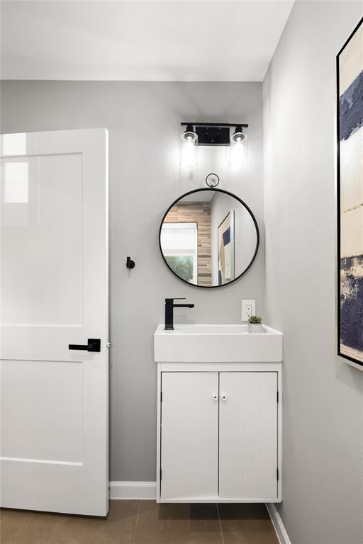 2728 Livingston Avenue Fort Worth, TX 76110 - Photo 4 of 37 a bathroom with a sink a mirror and vanity