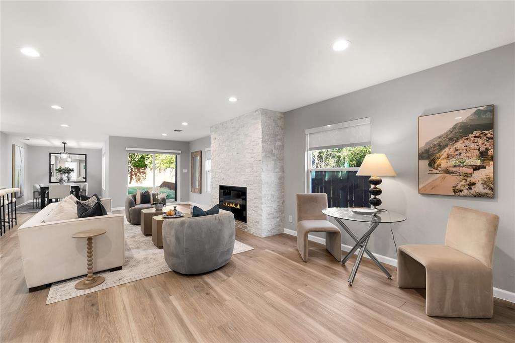 2728 Livingston Avenue Fort Worth, TX 76110 - Photo 7 of 37 a living room with furniture a wooden floor and a large window