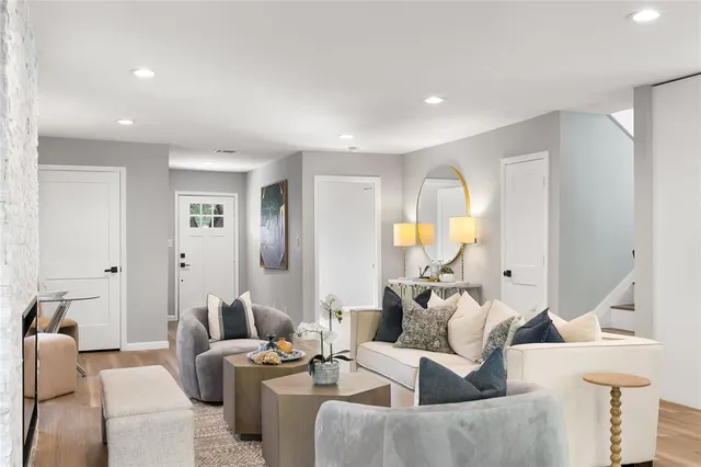 a living room with furniture a fireplace and a large window