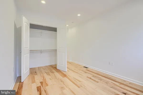 a view of an empty room with stairs and a window