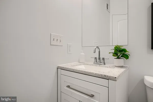 a bathroom with a toilet a sink and mirror