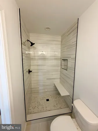 a kitchen with stainless steel appliances white cabinets and a stove top oven
