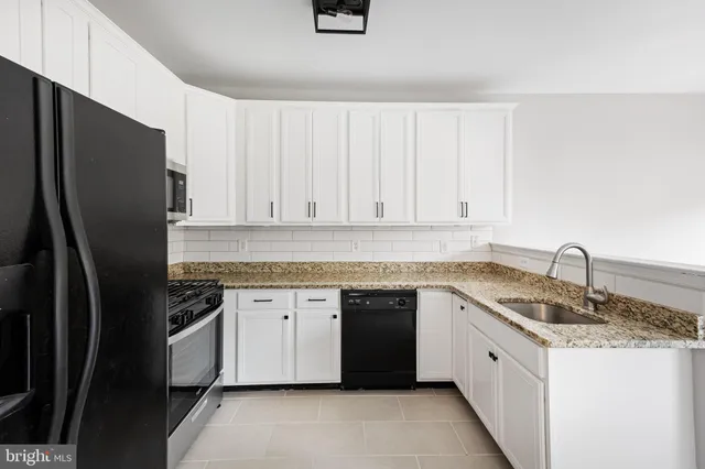 a kitchen with a sink stove and refrigerator