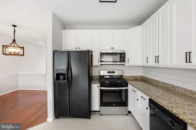 a view of a room with wooden floor and windows