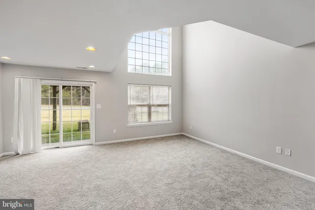 a view of building with glass windows and a yard