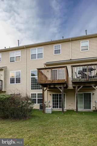 a balcony with wooden floor and fence