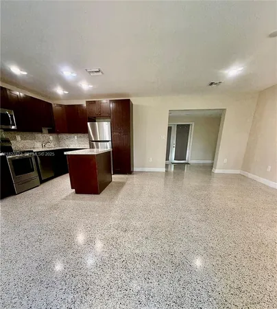 a view of kitchen and kitchen with microwave
