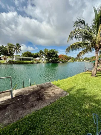 a view of a lake with houses in the back
