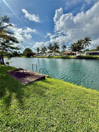 a view of a lake with houses in the back