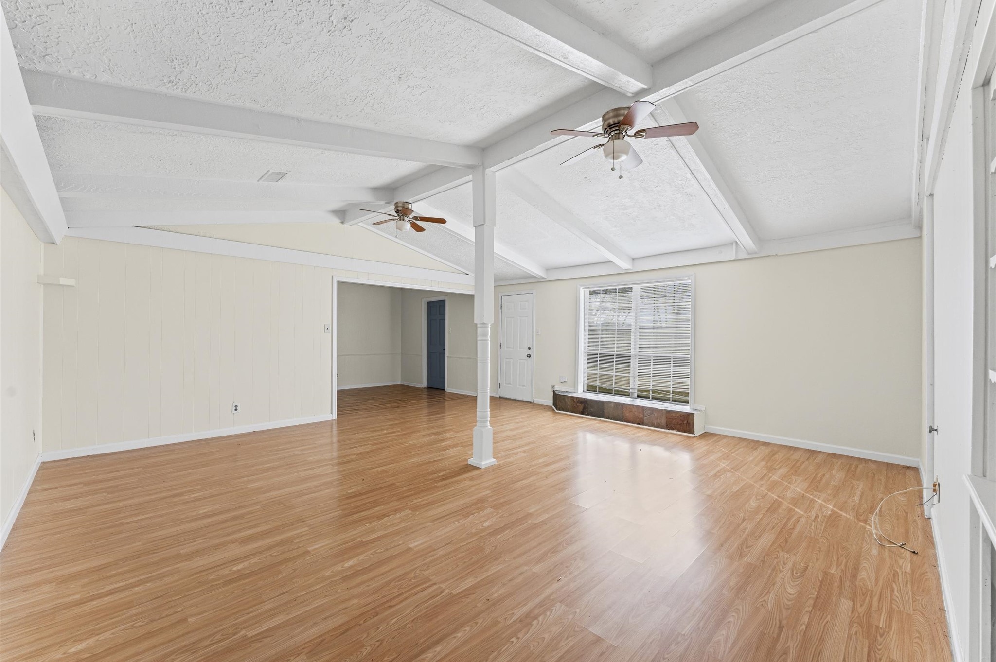 2709 Adams Street Alvin, TX 77511 - Photo 15 of 32 an empty room with wooden floor ceiling fan and windows